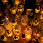 Top view of illuminated grave candles creating a warm glow at night.