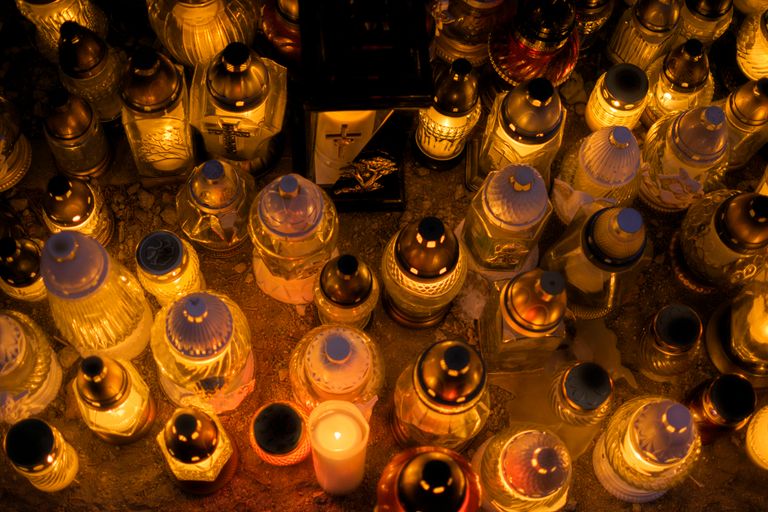 Top view of illuminated grave candles creating a warm glow at night.